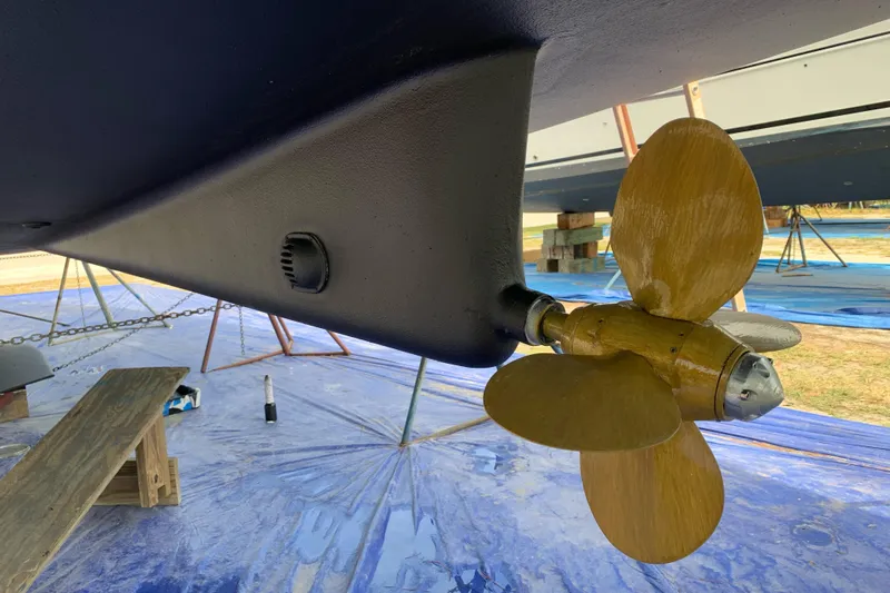 Here & Now Yacht Photos Pics Catalina 445 sailboat propeller and hull, 2021 model, on dry dock for maintenance.
