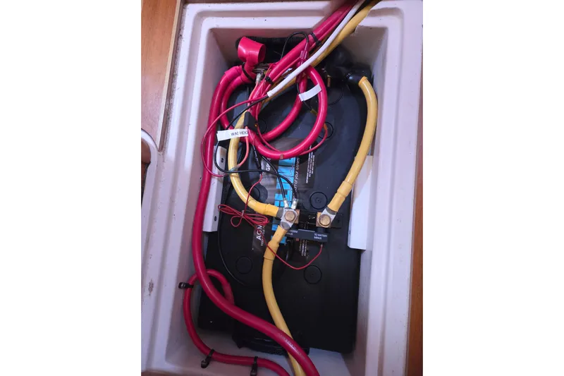 Here & Now Yacht Photos Pics Battery compartment of 2021 Catalina 445 sailboat with red and yellow cables.