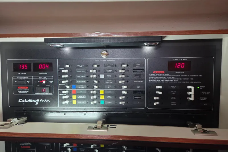 Here & Now Yacht Photos Pics Electrical control panel of a 2021 Catalina 445 yacht, displaying voltage and switches.