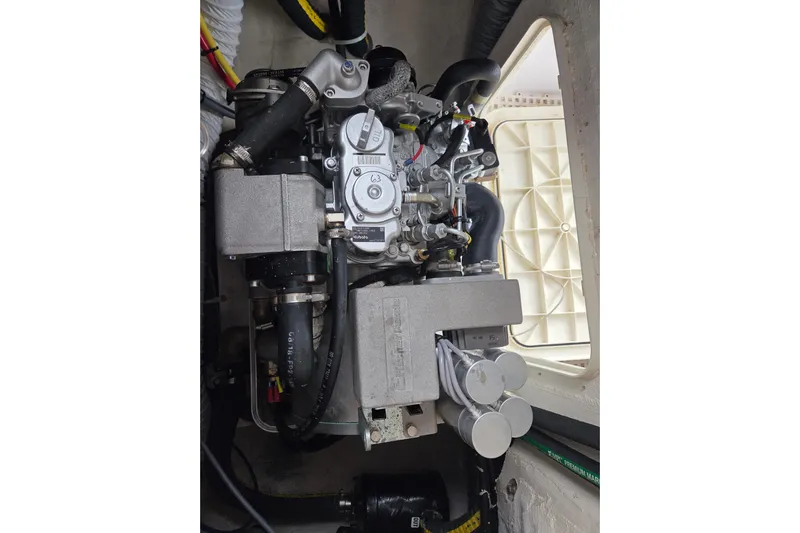 Here & Now Yacht Photos Pics Engine compartment of a 2021 Catalina 445 sailboat, showcasing detailed mechanical components.