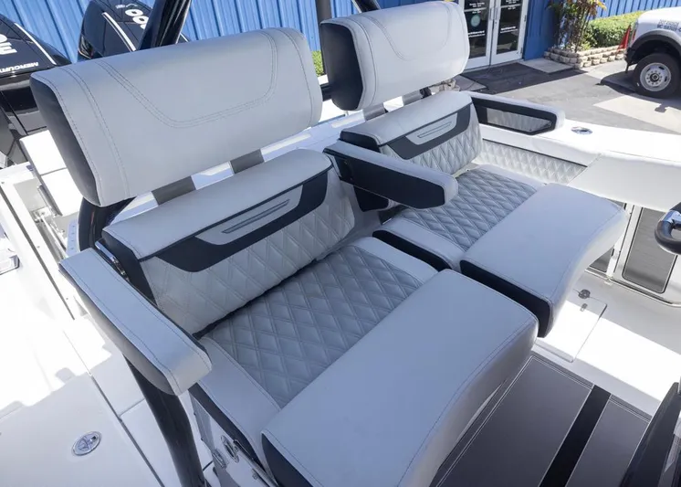  Yacht Photos Pics 2023 Blackfin 272 CC boat seats with diamond stitching and armrests, showcasing luxury design.
