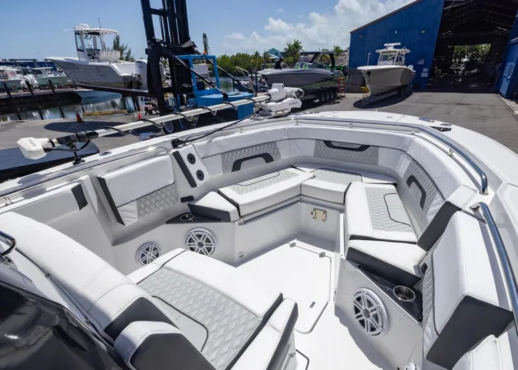  Yacht Photos Pics 2023 Blackfin 272 CC boat interior with luxurious seating and modern design at a marina.