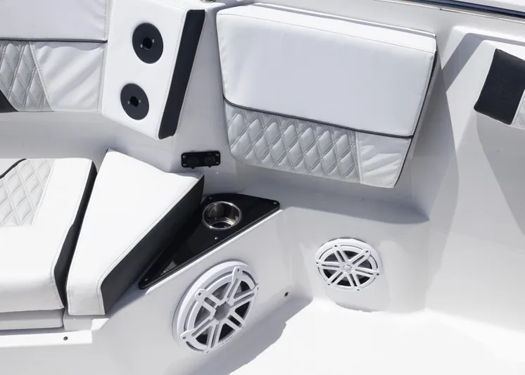  Yacht Photos Pics 2023 Blackfin 272 CC boat interior with white cushioned seating and speaker system.