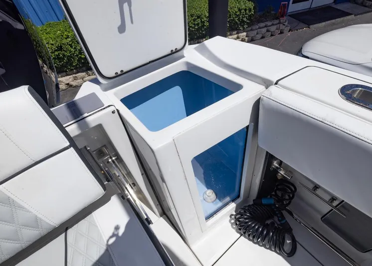  Yacht Photos Pics 2023 Blackfin 272 CC boat storage compartment with open lid and coiled cable.