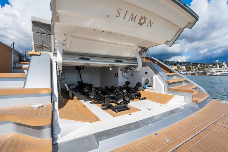 Simon Yacht Photos Pics 2024 Pardo Yachts GT75 with open storage compartment, docked by the sea.
