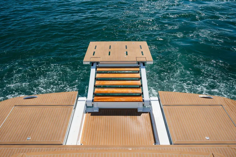 Simon Yacht Photos Pics 2024 Pardo Yachts GT75 swim platform with wooden steps over ocean water.