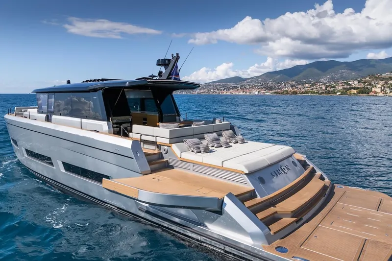 Simon Yacht Photos Pics 2024 Pardo Yachts GT75 luxury yacht cruising on blue ocean near scenic coastline.