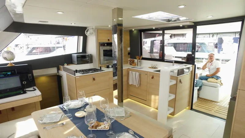 Tbd Yacht Photos Pics Luxurious interior of 2025 Aventura 45 yacht with modern kitchen and dining area.