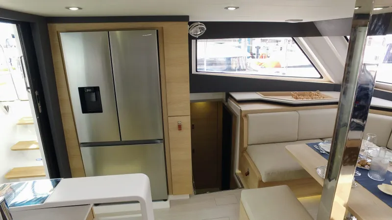 Tbd Yacht Photos Pics Luxurious interior of 2025 Aventura 45 yacht with modern kitchen and dining area.