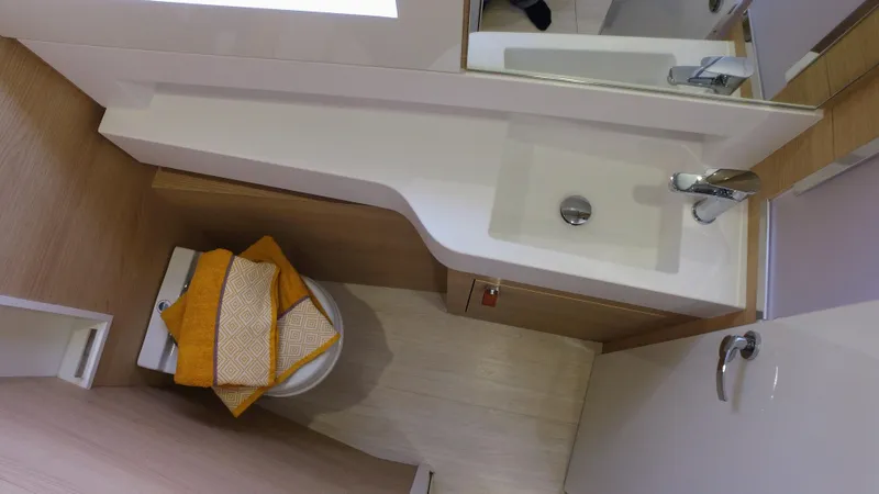 Tbd Yacht Photos Pics Compact bathroom in 2025 Aventura 45 yacht with modern sink and toilet.