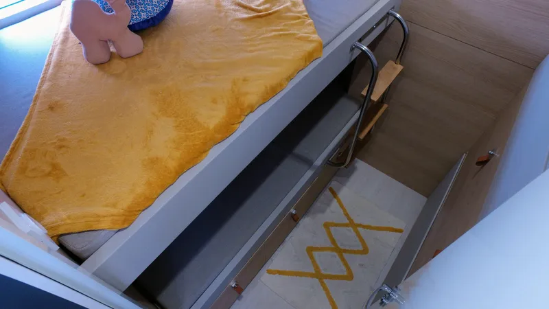 Tbd Yacht Photos Pics Interior of Aventura 45 yacht, 2025 model, featuring a cozy bed with yellow blanket.