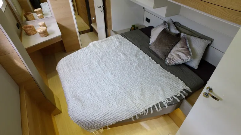 Tbd Yacht Photos Pics Cozy bedroom in 2025 Aventura 45 yacht with modern decor and comfortable bedding.