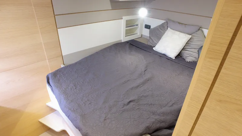 Tbd Yacht Photos Pics Cozy bedroom in 2025 Aventura 45 yacht with modern design and soft lighting.