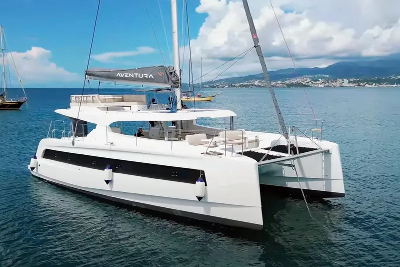 Tbd Yacht Photos Pics 2025 Aventura 45 catamaran sailing on calm blue waters under a clear sky.