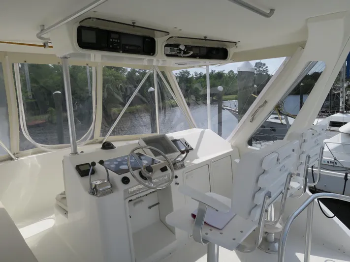 Bayou Bandit Yacht Photos Pics 1999 Ocean Yachts helm station with steering wheel, controls, and navigation equipment.