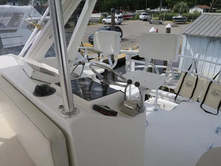 Bayou Bandit Yacht Photos Pics 1999 Ocean Yachts helm station with dual captain chairs and control panel.