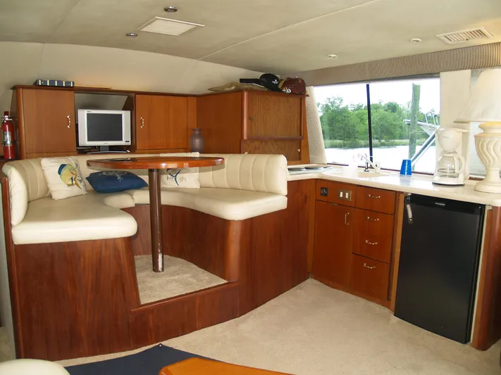 Bayou Bandit Yacht Photos Pics Interior of 1999 Ocean Yachts model with kitchenette, dining area, and TV.