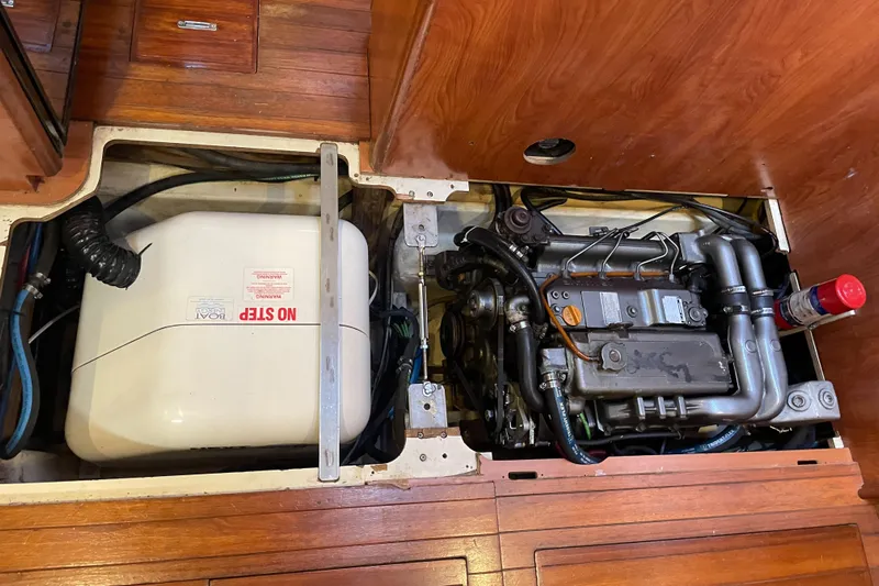 Sailing Diver Yacht Photos Pics Engine compartment of 2010 Hunter 49 Aft Cockpit sailboat, featuring mechanical components and storage.