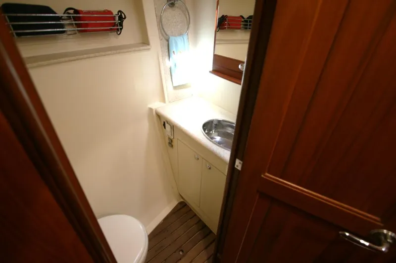 Sailing Diver Yacht Photos Pics Compact bathroom in 2010 Hunter 49 Aft Cockpit yacht with sink and toilet.