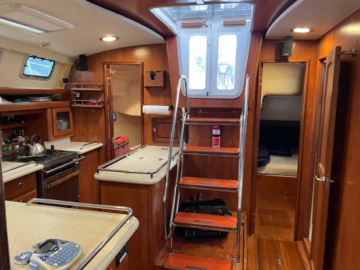 Sailing Diver Yacht Photos Pics Interior of 2010 Hunter 49 Aft Cockpit yacht with wooden cabinetry and modern amenities.