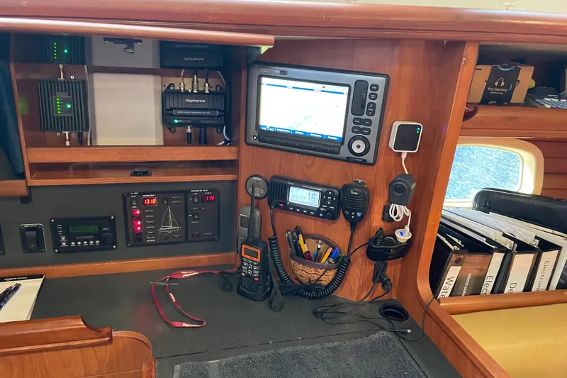Sailing Diver Yacht Photos Pics Navigation and communication equipment in a 2010 Hunter 49 Aft Cockpit sailboat cabin.