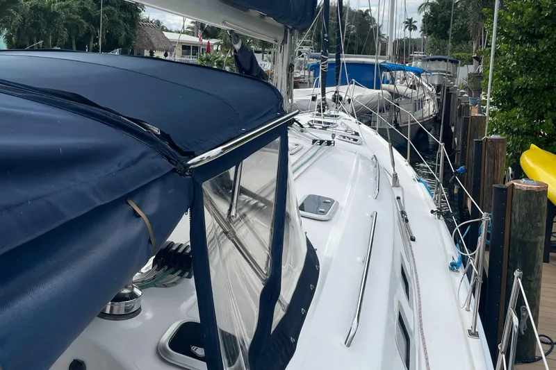 Sailing Diver Yacht Photos Pics 2010 Hunter 49 Aft Cockpit sailboat docked, featuring blue covers and sleek white deck.