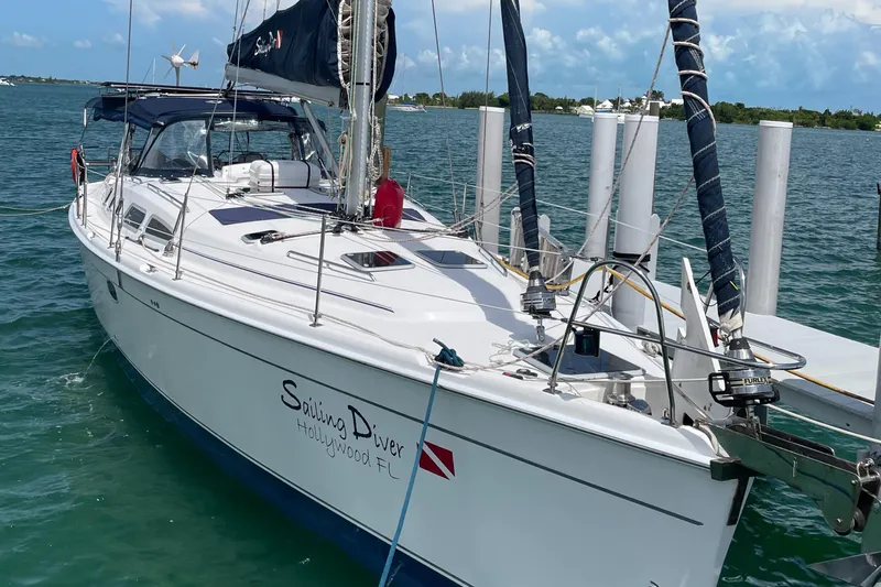 Sailing Diver Yacht Photos Pics 2010 Hunter 49 Aft Cockpit sailboat docked in clear blue water.