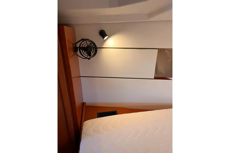 Grey Havens Yacht Photos Pics Interior cabin of 2017 Beneteau Oceanis 38.1 yacht with bed and wall light.