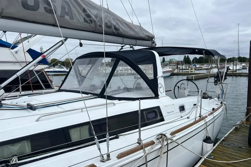 Grey Havens Yacht Photos Pics 2017 Beneteau Oceanis 38.1 sailboat docked at marina, featuring sleek design and canopy.