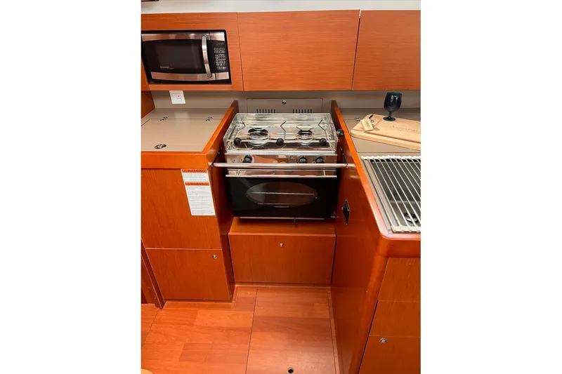 Grey Havens Yacht Photos Pics Galley kitchen in 2017 Beneteau Oceanis 38.1 yacht with stove and microwave.