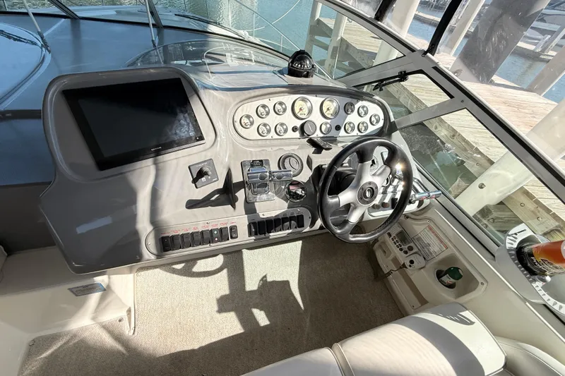 Ursula Yacht Photos Pics Helm of 2006 Cruisers Yachts 370 Express with steering wheel and control panel.