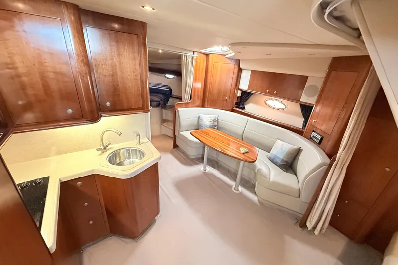 Ursula Yacht Photos Pics Luxurious 2006 Cruisers Yachts 370 Express interior with elegant wood cabinetry and cozy seating area.