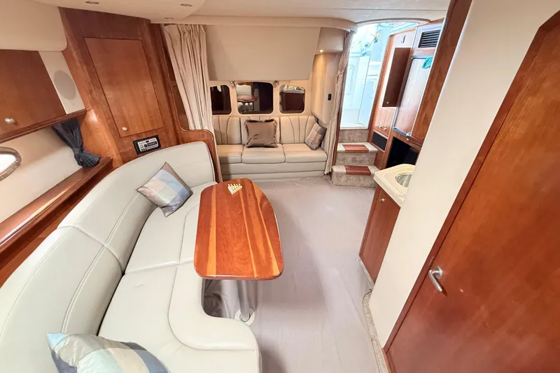 Ursula Yacht Photos Pics Luxurious interior of 2006 Cruisers Yachts 370 Express with elegant seating and wooden finishes.