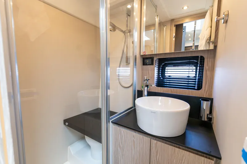 Yacht Photos Pics Luxurious bathroom in 2023 Azimut Atlantis 45 yacht with modern fixtures and sleek design.