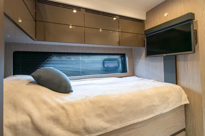  Yacht Photos Pics Luxurious cabin interior of 2023 Azimut Atlantis 45 yacht with bed and TV.