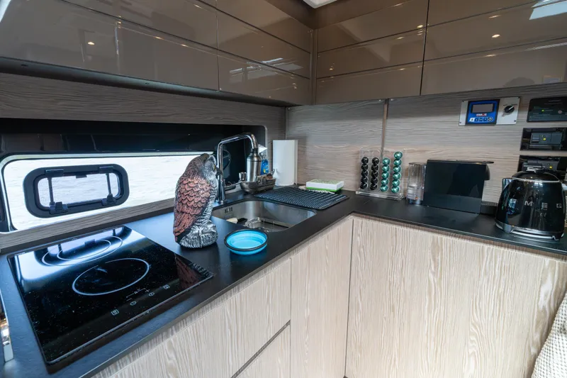  Yacht Photos Pics Modern kitchen interior of 2023 Azimut Atlantis 45 yacht with sleek appliances and decor.