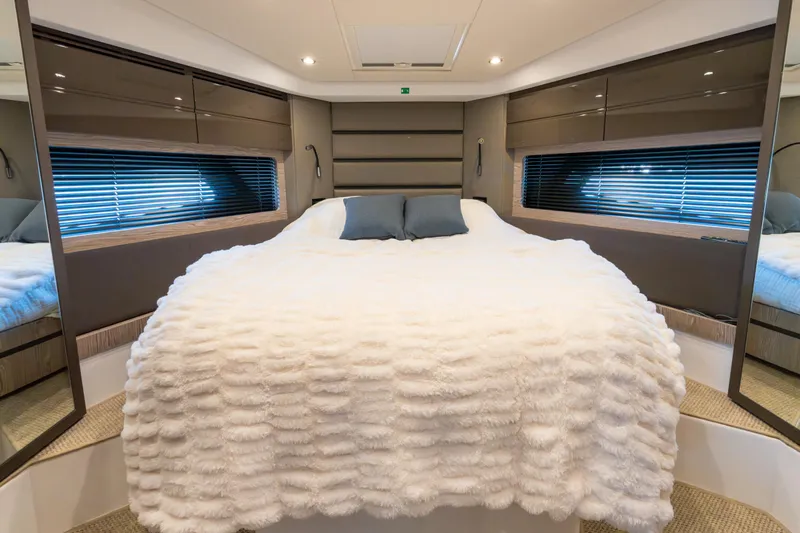  Yacht Photos Pics Luxurious bedroom interior of 2023 Azimut Atlantis 45 yacht with plush bedding.