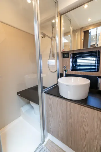  Yacht Photos Pics Modern bathroom in 2023 Azimut Atlantis 45 yacht with sleek fixtures and elegant design.