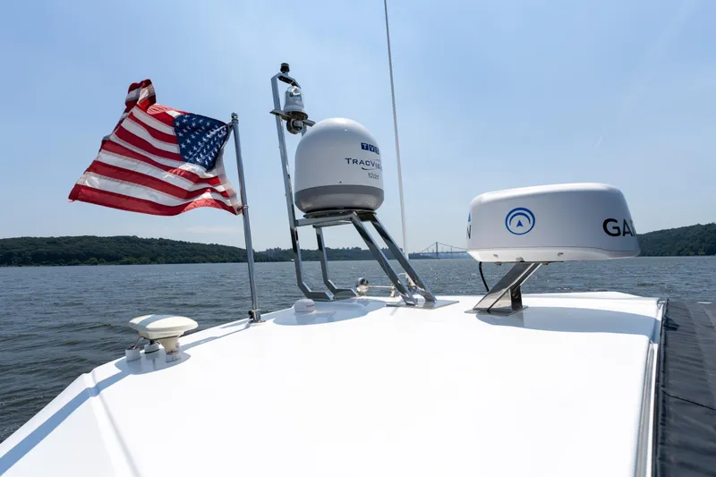  Yacht Photos Pics Azimut Atlantis 45 yacht with American flag, radar equipment, and scenic water view, 2023 model.