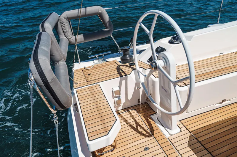 Azucar Yacht Photos Pics 2023 Bavaria C42 yacht cockpit with wooden deck and steering wheel on open water.