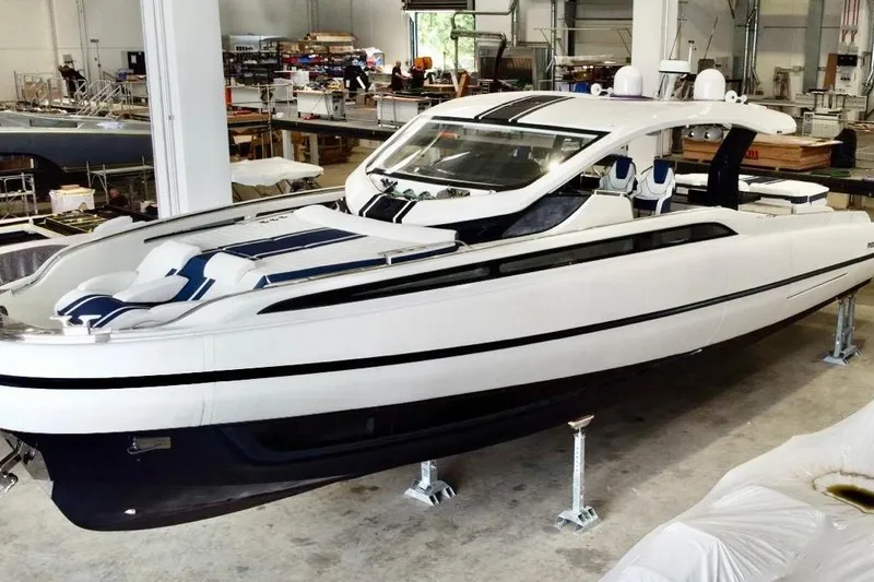  Yacht Photos Pics 2025 SACS Rebel 55 luxury yacht in a shipyard, showcasing sleek design and modern features.