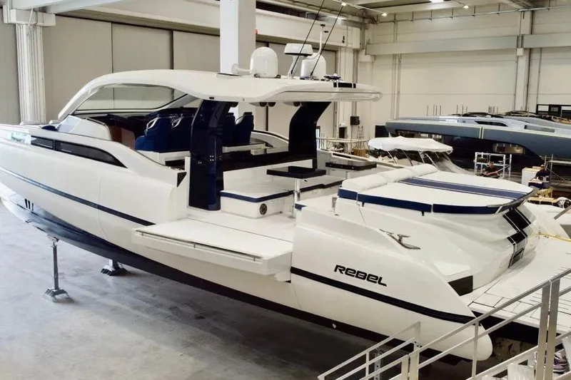  Yacht Photos Pics 2025 SACS Rebel 55 luxury yacht in a showroom, showcasing sleek design and modern features.