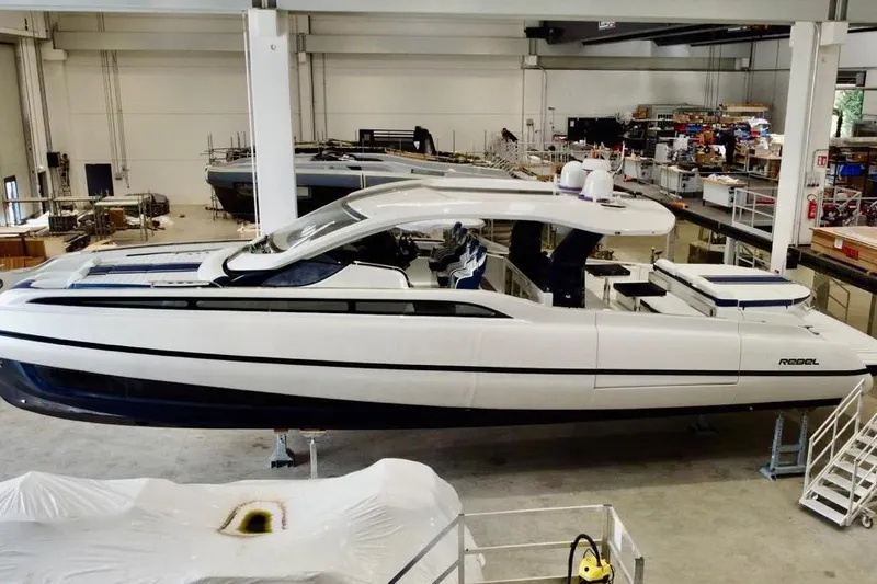  Yacht Photos Pics 2025 SACS Rebel 55 luxury yacht in a modern indoor shipyard setting.