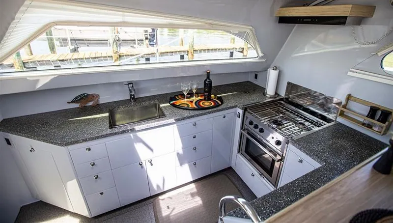 Wabisabi Yacht Photos Pics Modern yacht kitchen with sleek countertops, stove, and sink in a 2018 Chris White Atlantic 49 MastFoil.