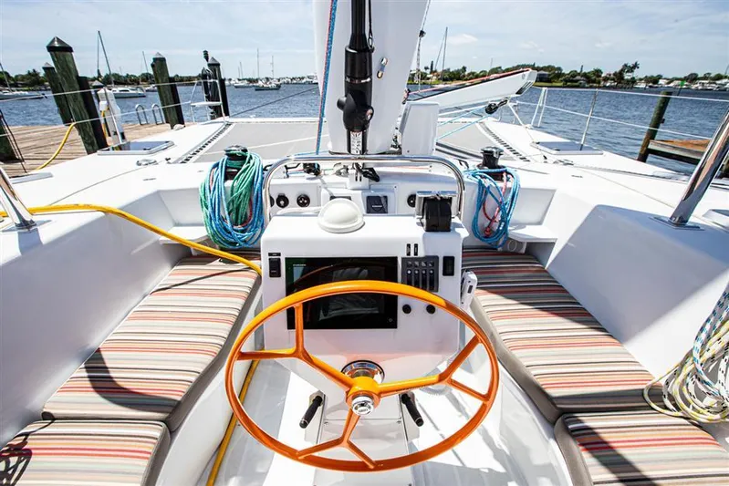 Wabisabi Yacht Photos Pics Cockpit of 2018 Chris White Atlantic 49 MastFoil sailboat with striped seating and orange wheel.