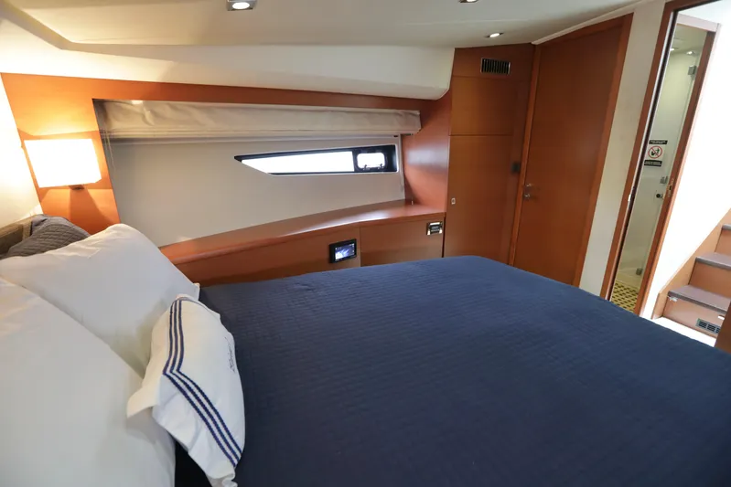 Perseus Yacht Photos Pics Prestige 500 2013 yacht bedroom with blue bedding and wooden interior.