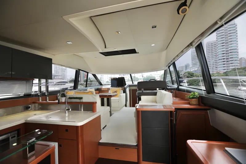 Perseus Yacht Photos Pics Interior of a 2013 Prestige 500 yacht with modern furnishings and cityscape view.