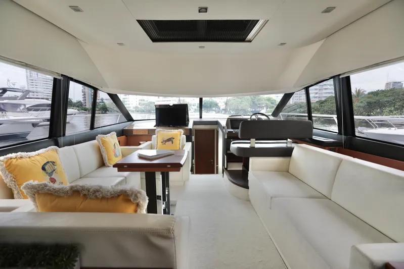 Perseus Yacht Photos Pics Interior of a 2013 Prestige 500 yacht with white seating and large windows.