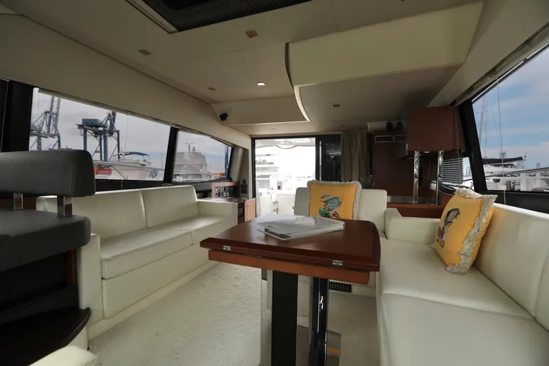 Perseus Yacht Photos Pics Interior of 2013 Prestige 500 yacht with white leather seating and wooden table.