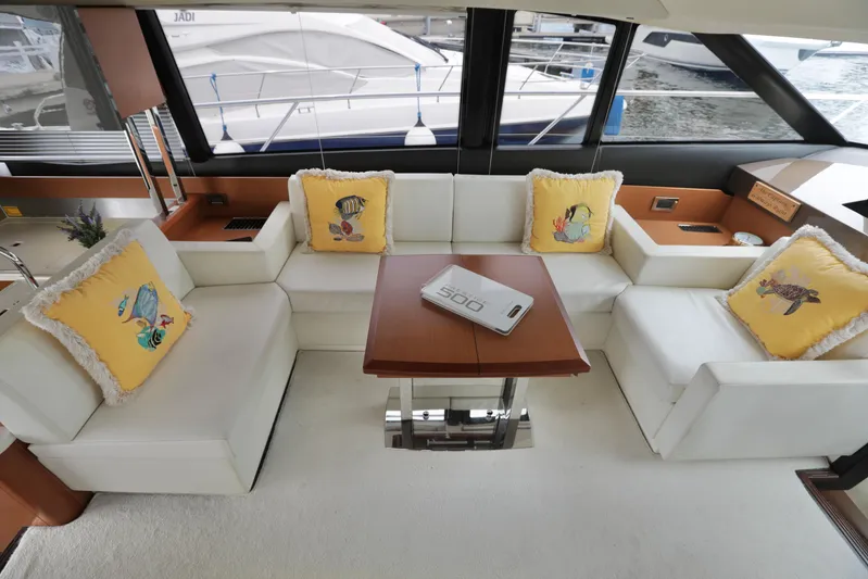 Perseus Yacht Photos Pics Prestige 500 yacht interior, 2013 model, with white seating and nautical-themed pillows.